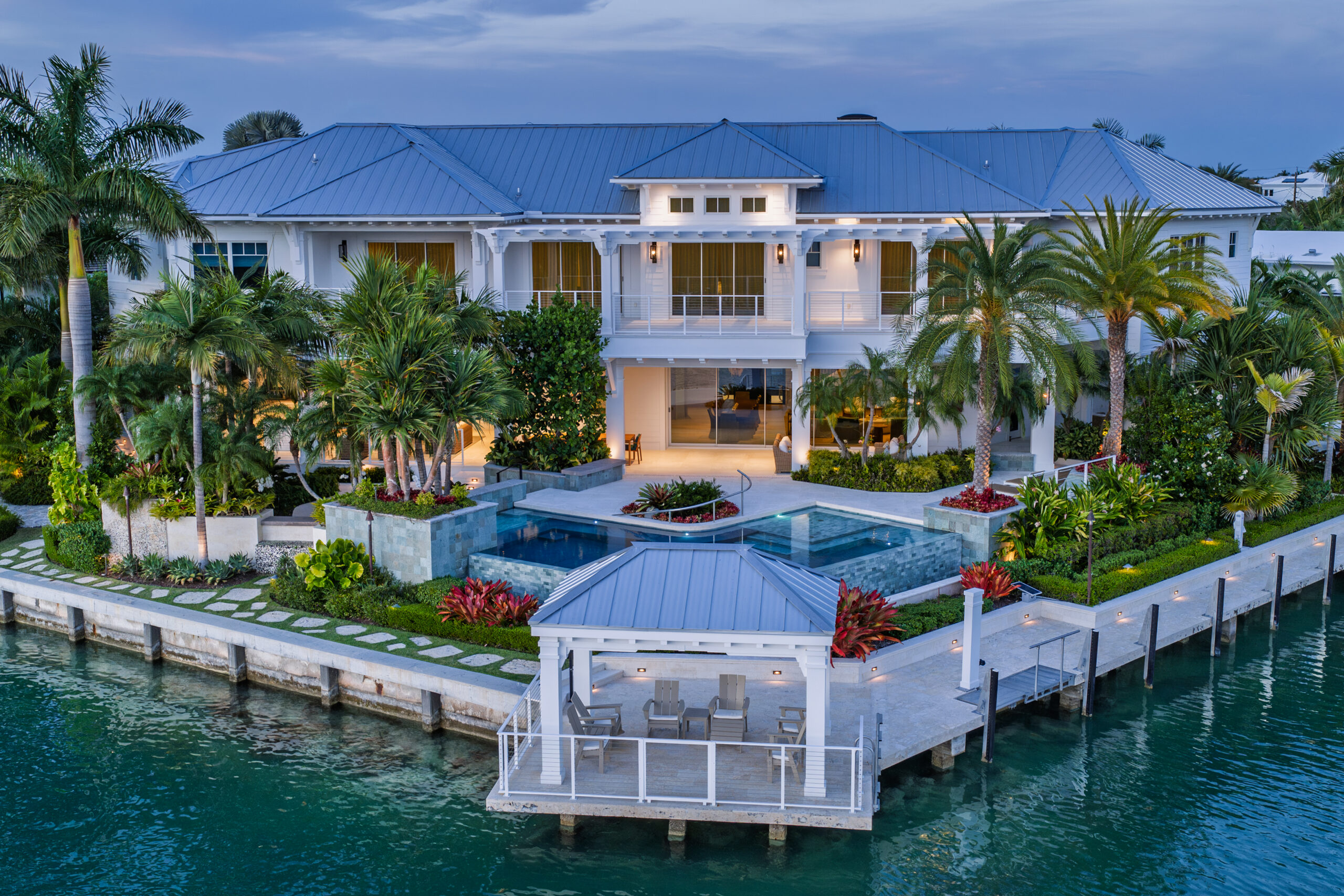 Elegant waterfront house with lush tropical gardens and a private pool.
